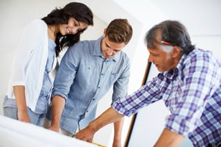 Couple discussing radon mitigation and testing with contractor