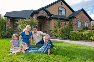 Family Sitting Outside House in the Grass